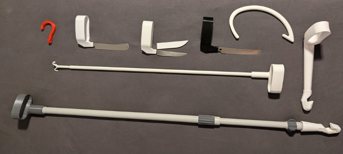 Eight objects on a dark gray surface: a red hook, three knives with 3D-printed handles, a white arc with a hook, and three sticks in various lengths with a handle on one end and a hook on the other end. 